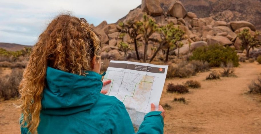 girl looking at map in national park