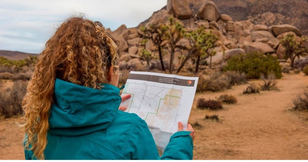 girl looking at map in national park