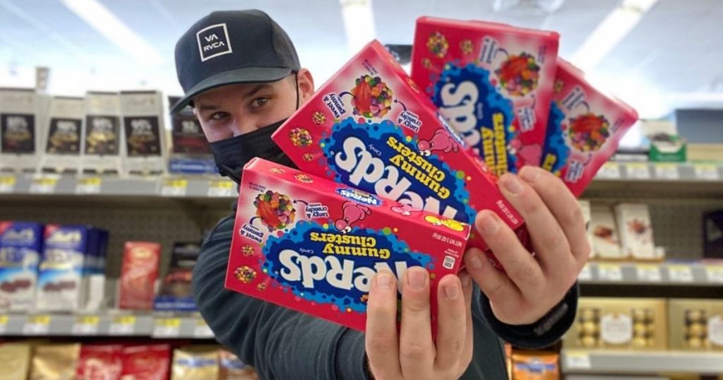 man holding 4 Nerds Gummy Clusters Candy Boxes