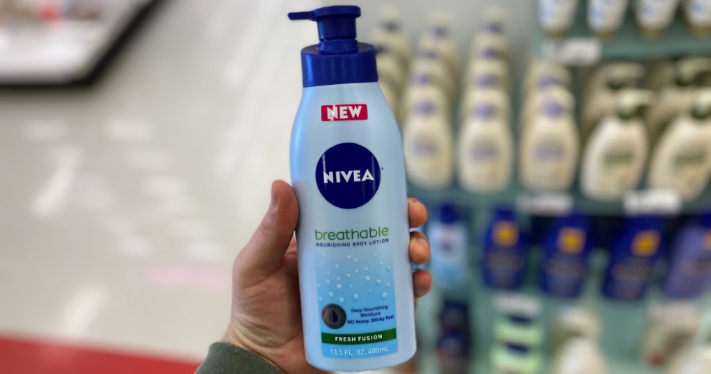 hand holding up Nivea Breathable lotion