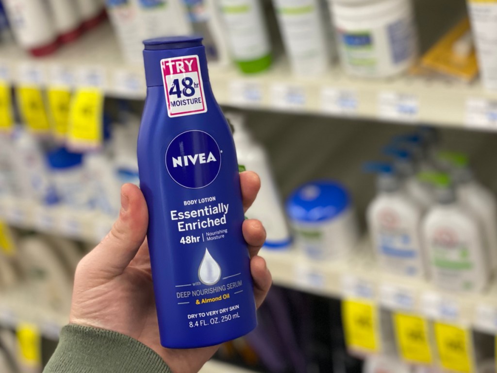 hand holding nivea body lotion at cvs