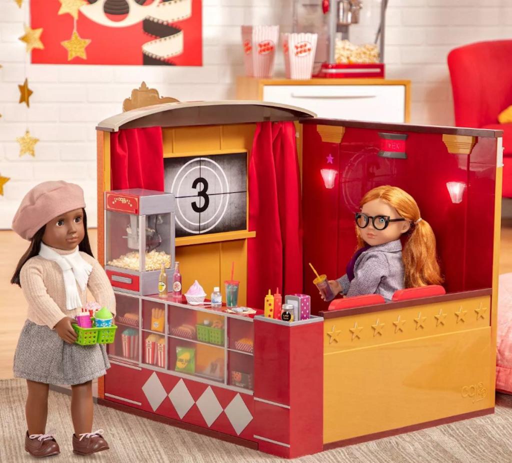 two our generation dolls with movie theatre set up