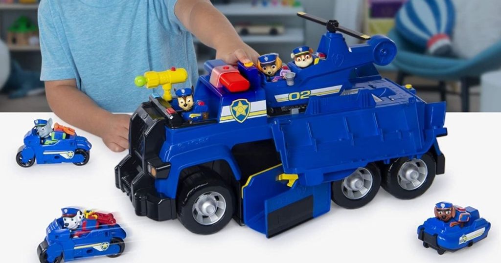 child playing with Paw Patrol Ultimate Police Cruiser with vehicles