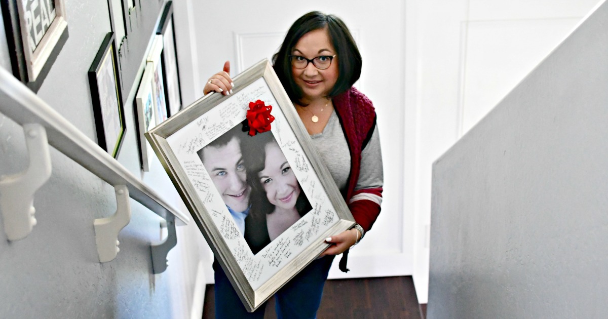woman holding framed photo with bow