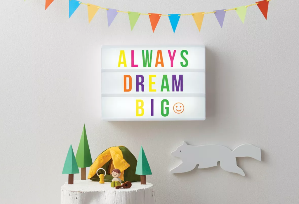 kids room with a lighted board on the wall