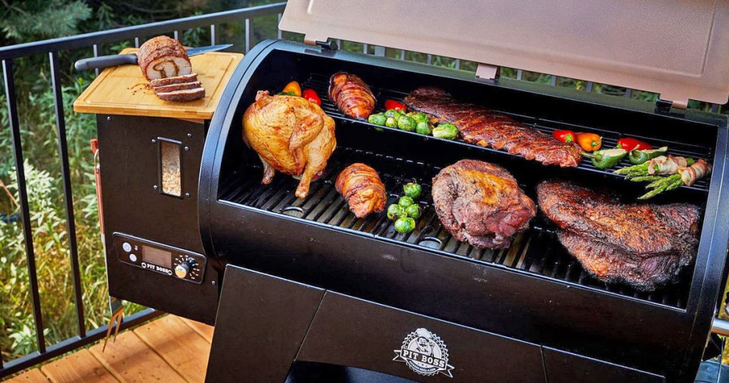 opened pellet grill with meats and vegetables on the cooking surfaces