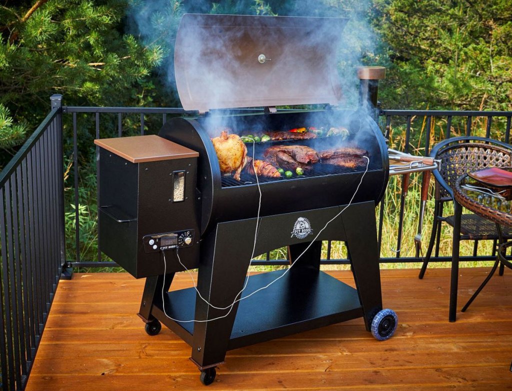 pellet grill on patio deck with foods smoking on the grilling surface