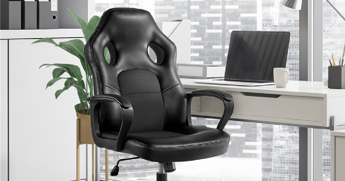 black padded high back computer chair in front of plant and next to desk