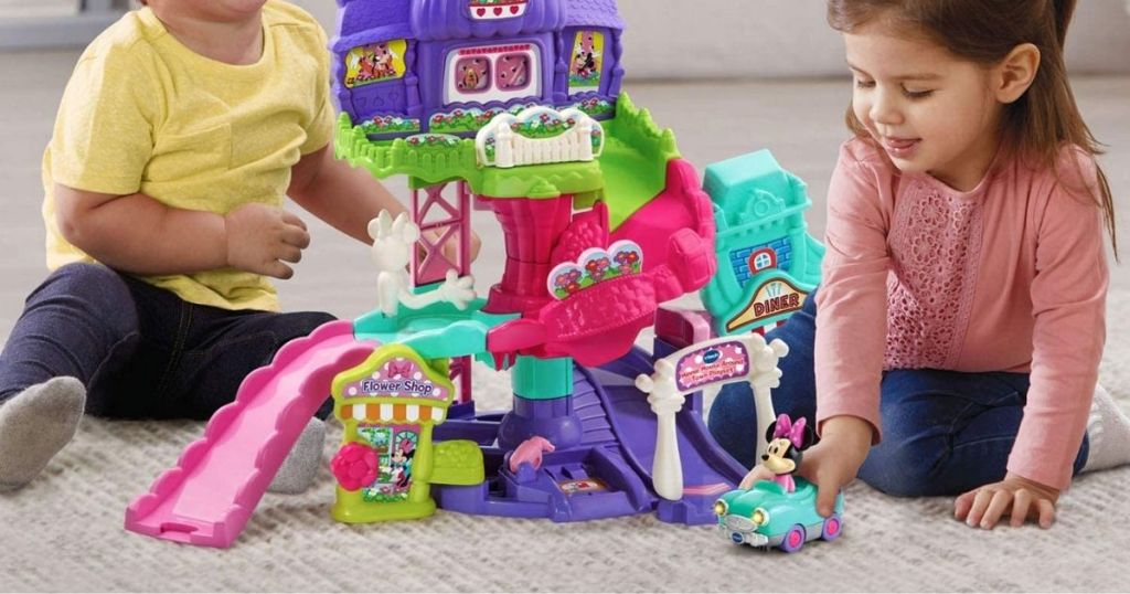 2 kids playing with VTech Disney Minnie Mouse About Town Playset