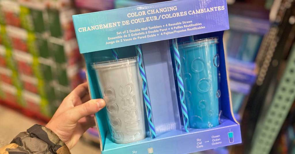 hand holding color changing tumblers in packages at costco