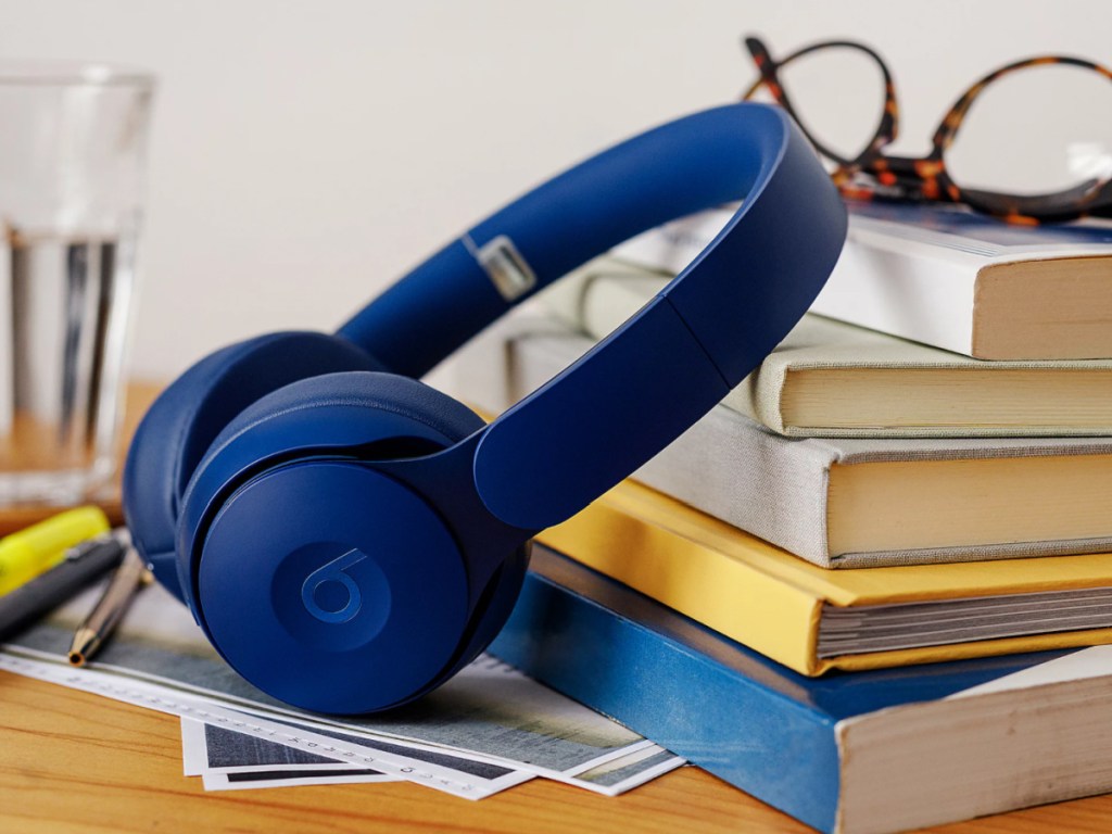 dark blue dark blue solo beats dr. dre leaning on a stack of books