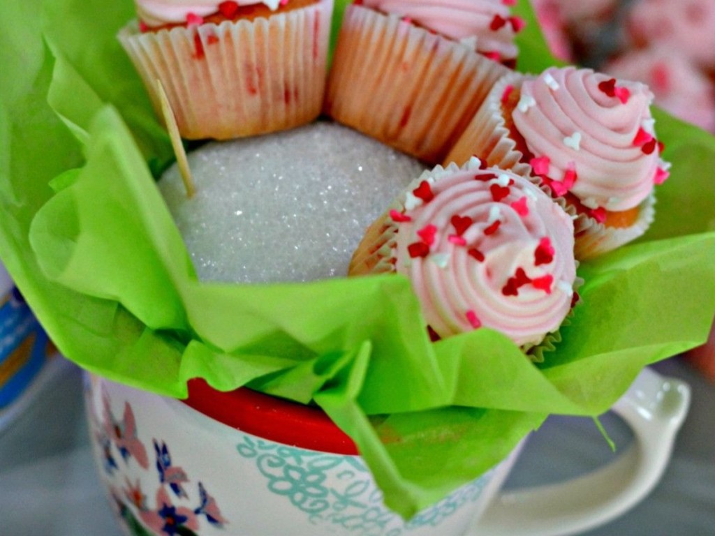 inserting cupcakes into foam ball