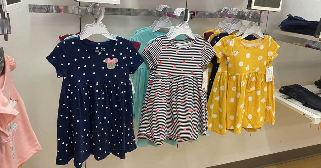 little girls dresses hanging up on display in store