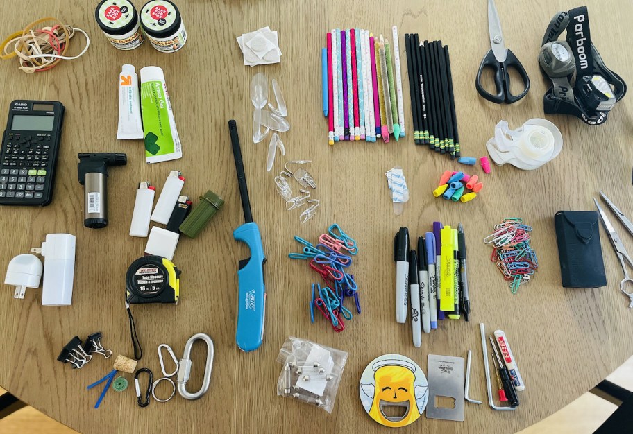 piles of junk drawer stuff on wood table