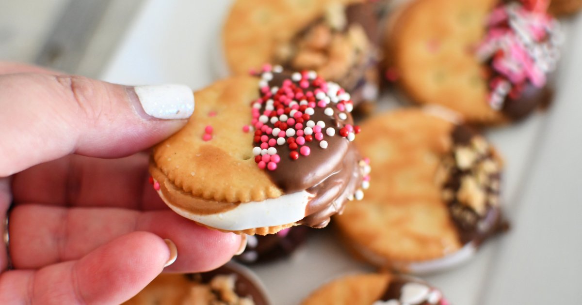 holding chocolate dipped fluffer nutters