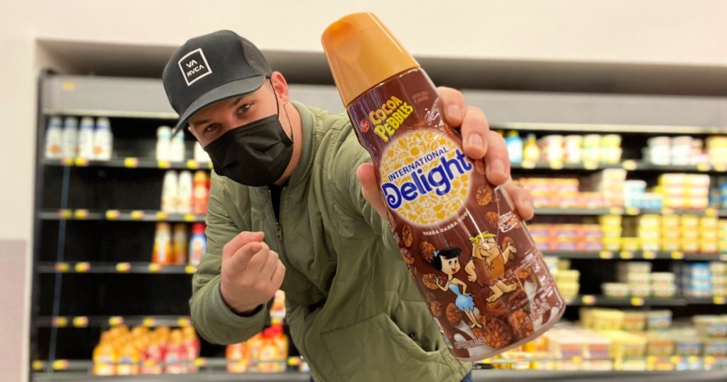 man holding cocoa pebbles international delight coffee creamer