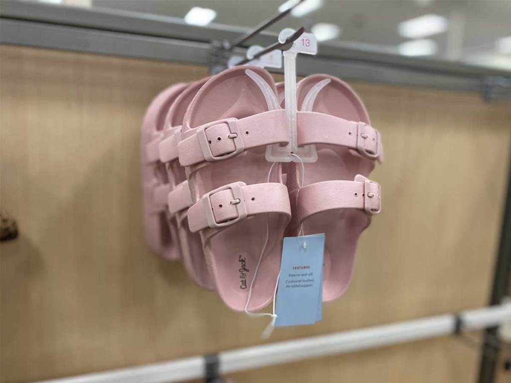 pair of pink sandals hanging up in store