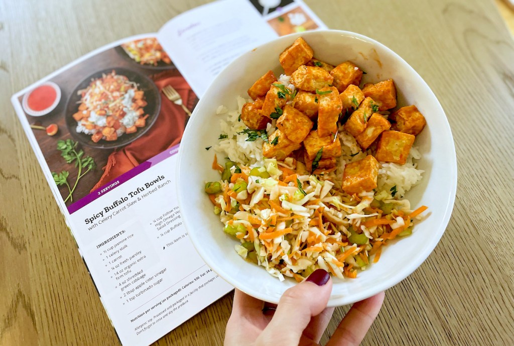 hand holding bowl of buffalo tofu from vegan meal kit