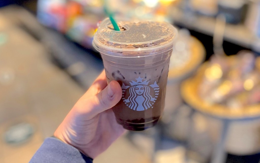 hand holding a starbucks drink in store