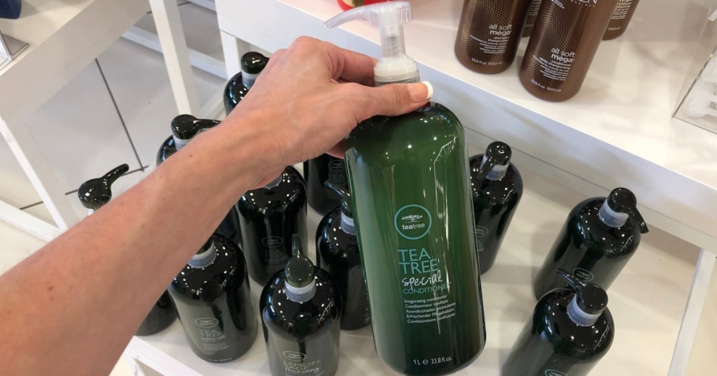 tea tree special shampoo in hand in store