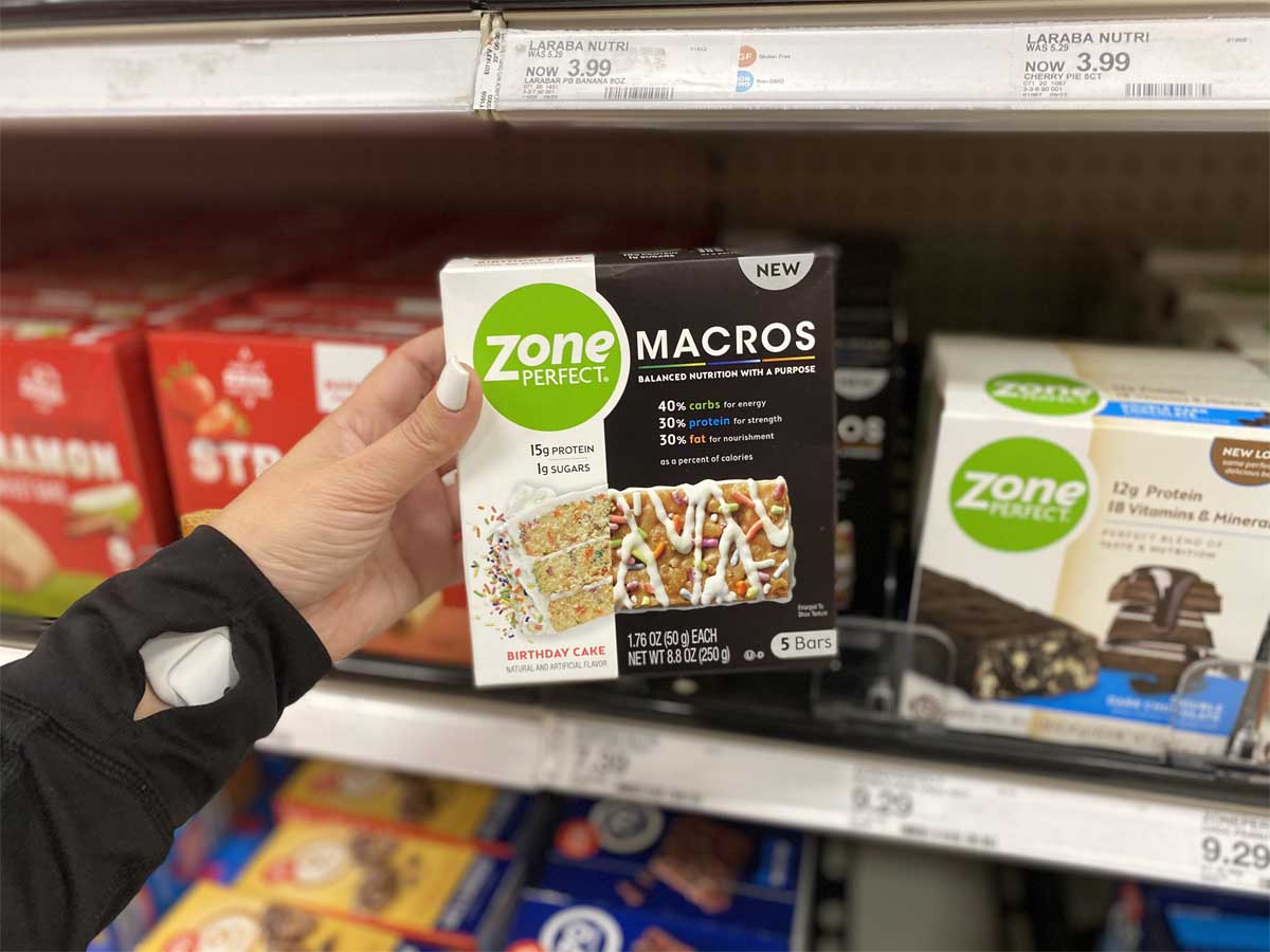 person holding up a box of zone perfect macro bars