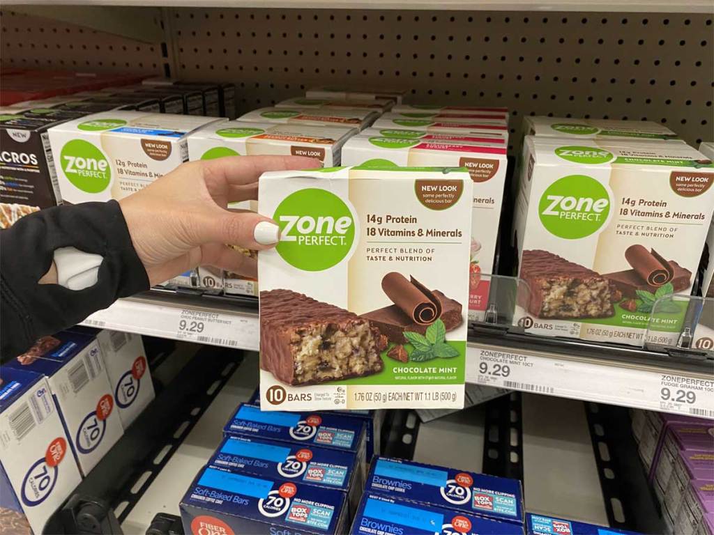 person holding up a box of zone perfect bars