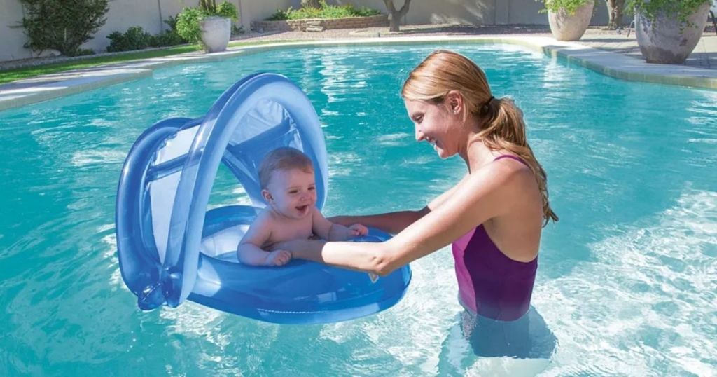 mom and baby in pool with baby floaty