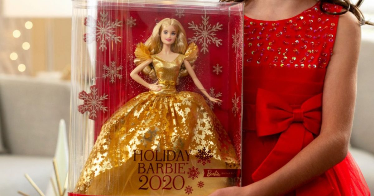 girl in red dress holding gold holiday edition Barbie