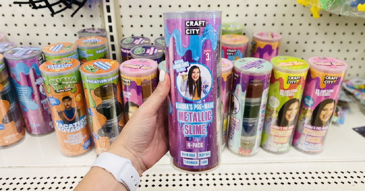 hand holding up a pack of slime tubs in front of a dollar tree store display