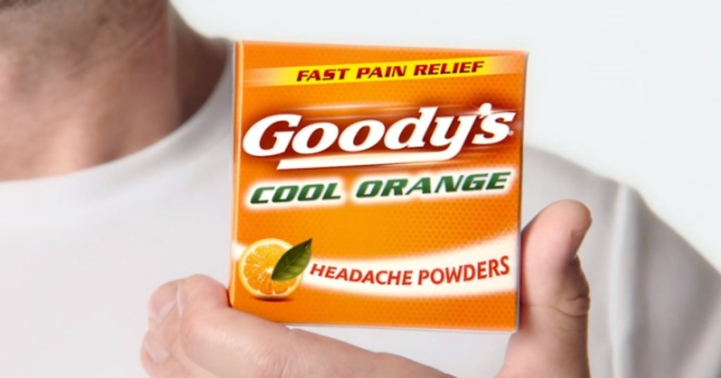 man in a white tee holding an orange box of Goody's Pain Relief