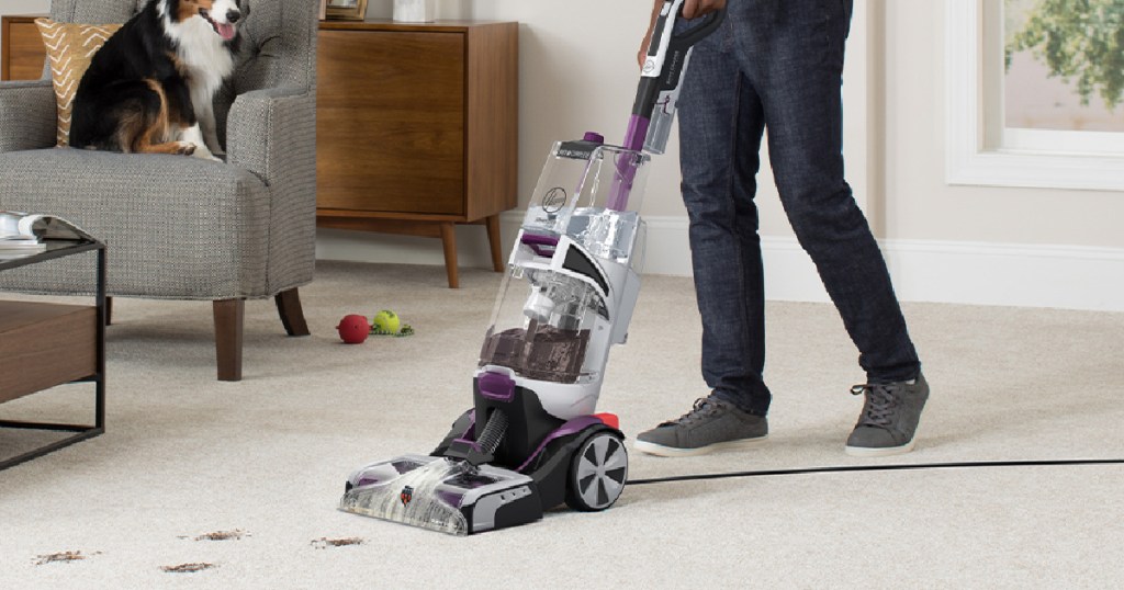 man cleaning carpet with dirt spots with the hoover smartwash