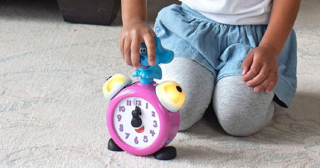 kid pressing down on blues clue on clock