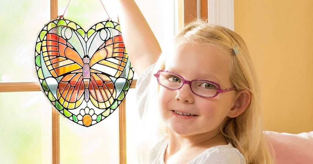 girl holding Melissa & Doug Butterfly Stained Glass Kit