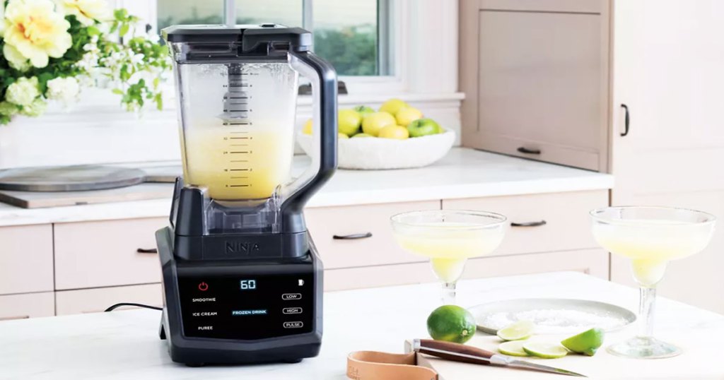 ninja blender on kitchen counter blending up margaritas