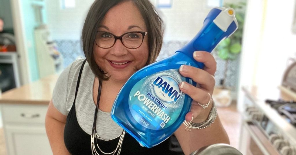 A woman holding Dawn dish spray