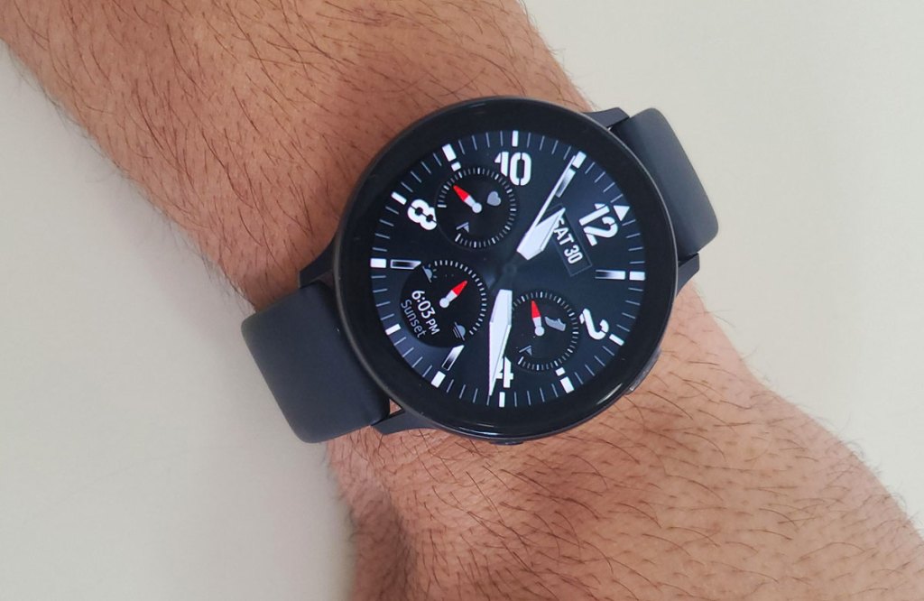 man with black samsung galaxy smartwatch on wrist