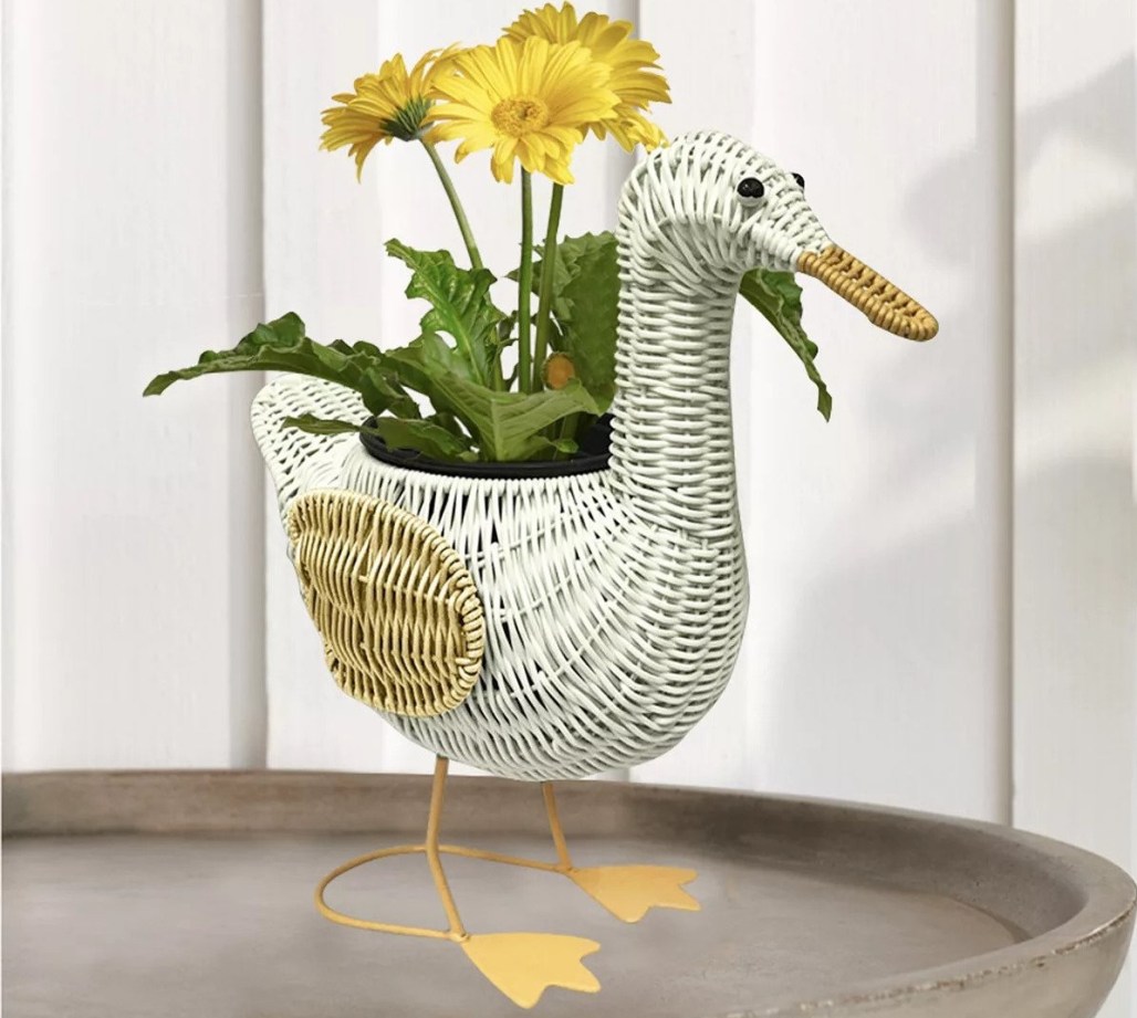 duck planter with a flower in it