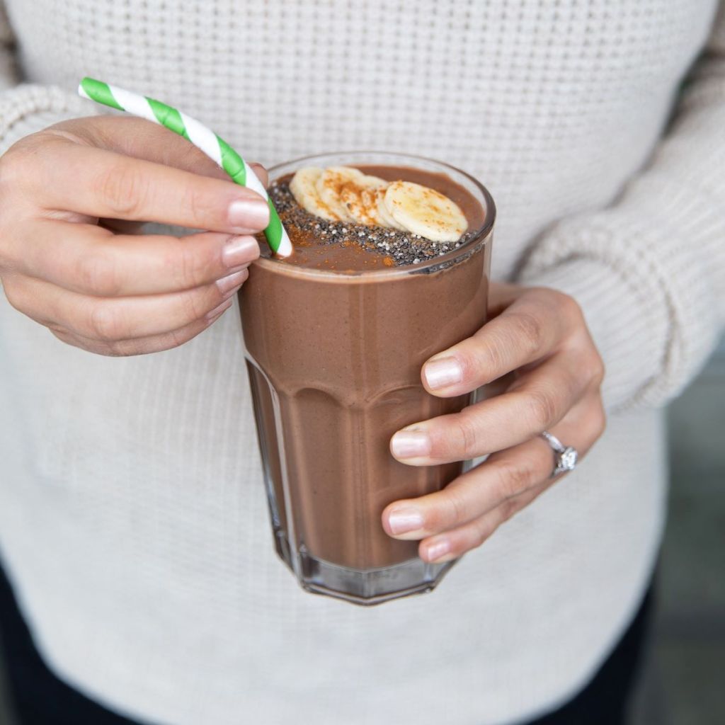 hands holding a protein shake