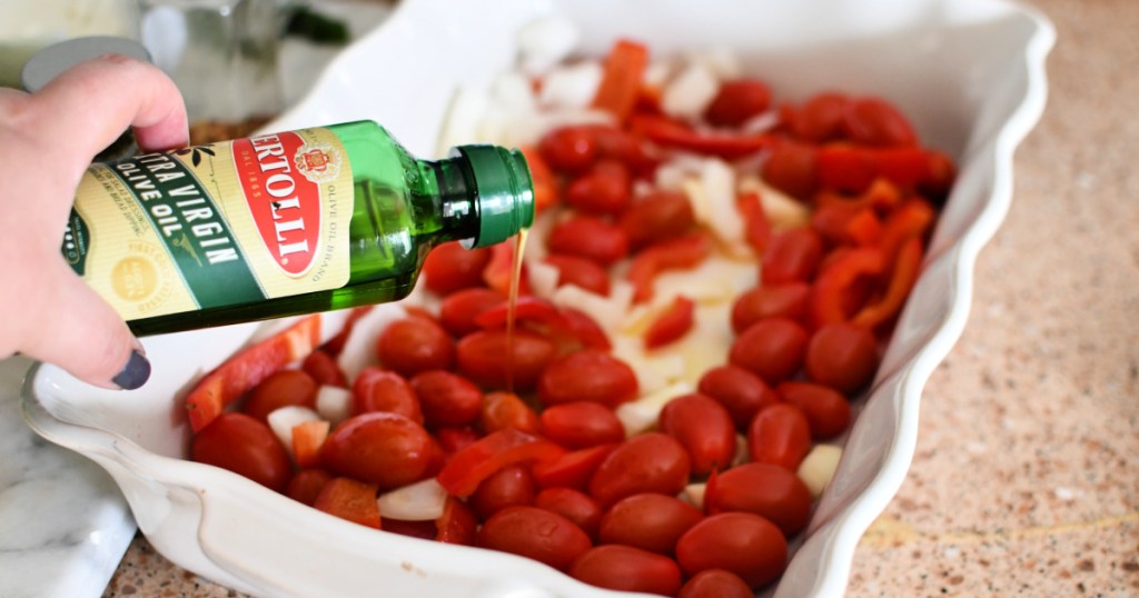 adding olive oil to feta pasta