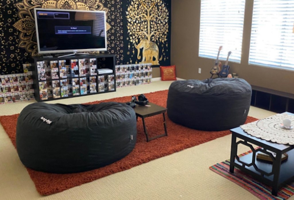 two dark gray lovesac bean bag chairs sitting in living room with tv media center