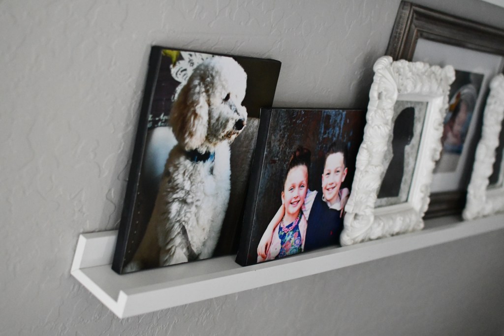 displaying diy photo canvases on a picture frame ledge