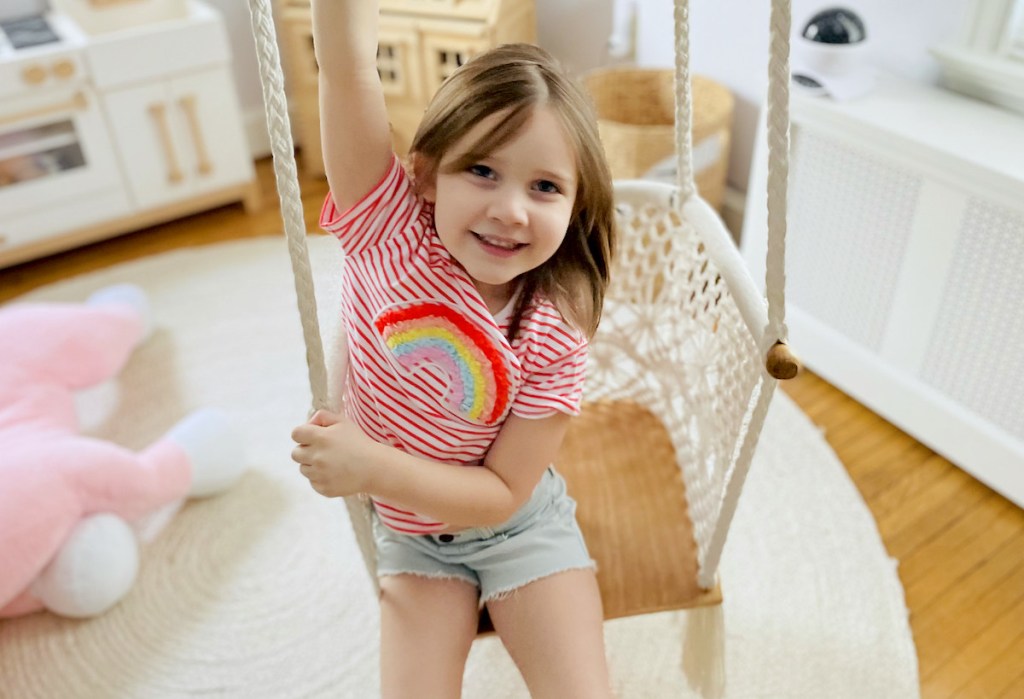 girl sitting on macrame swing wearing cheap kids clothes from garanimals