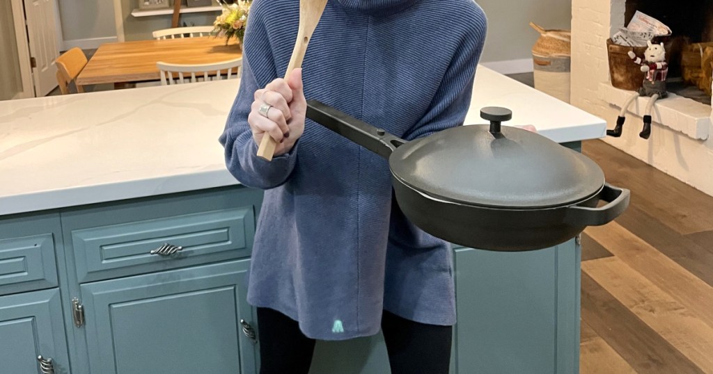 woman holding always pan in kitchen