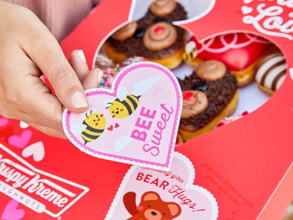 handing someone a heart-shaped Valentine