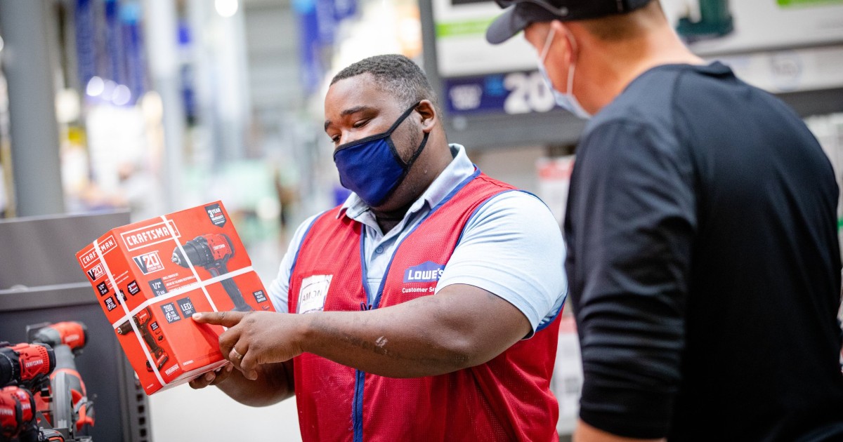 masked Lowe's employee helping customer