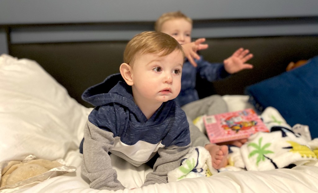 baby boy crawling on bed wearing cheap kids clothes