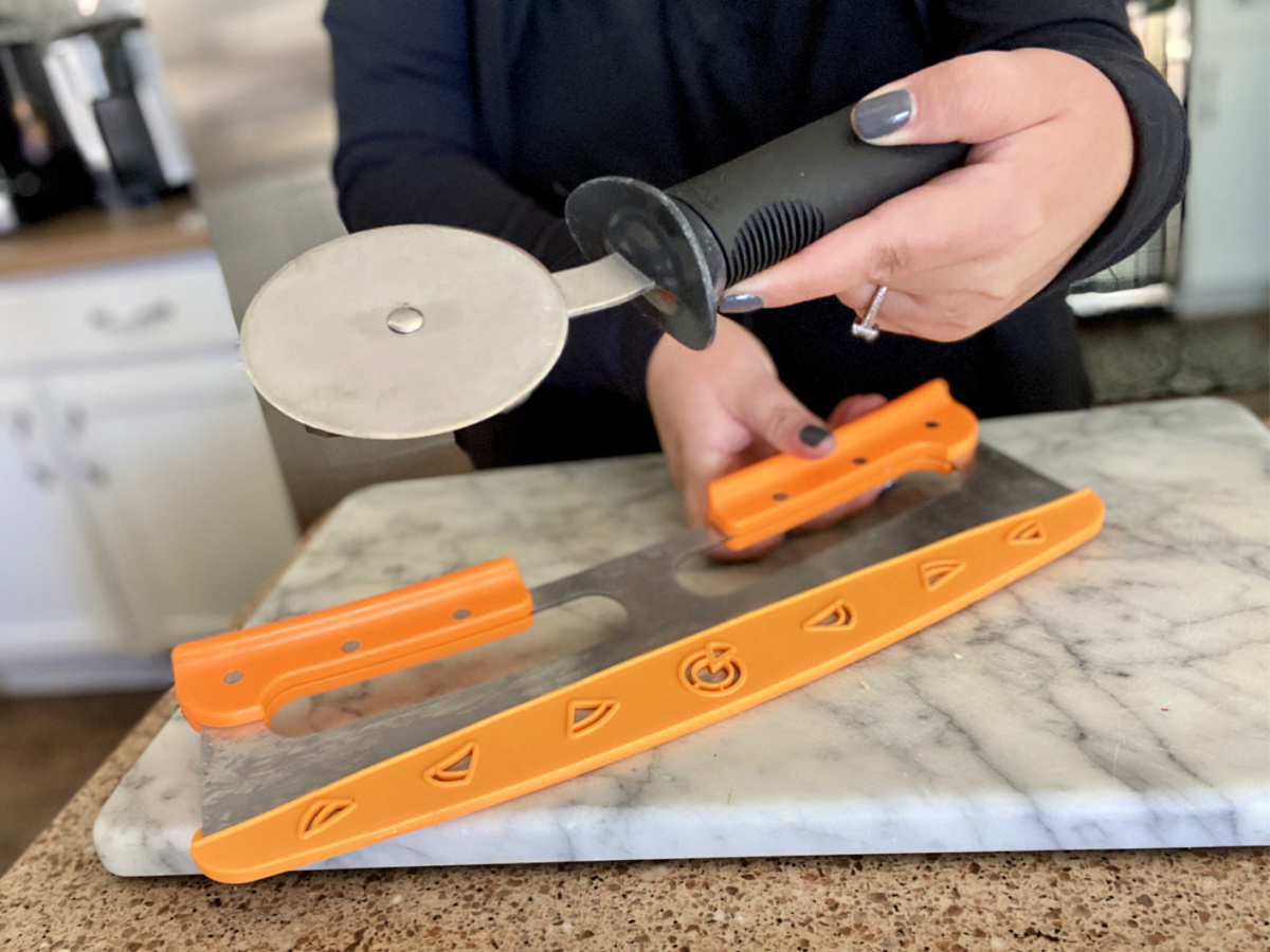 woman holding a pizza wheel cutter