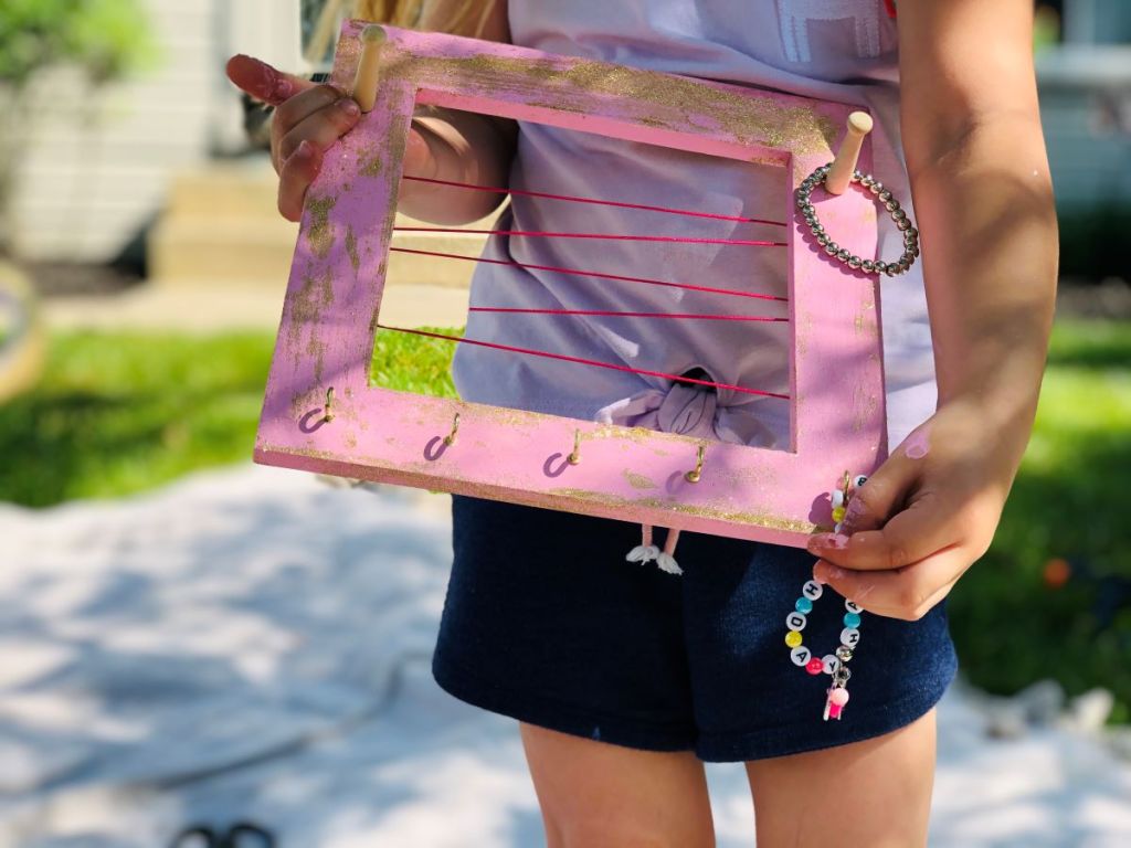 girl holding a jewelry organizer