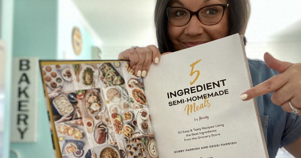 woman holding 5-ingredient semi-homemade meals cookbook