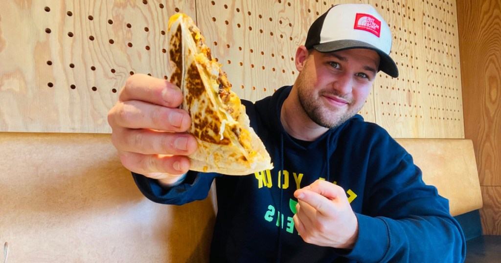 man holding a quesadilla